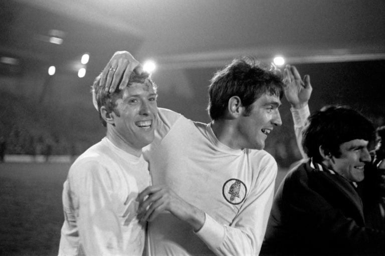 Hunter, right, celebrates with Leeds team-mate Mick Jones after securing the 1969 First Division title