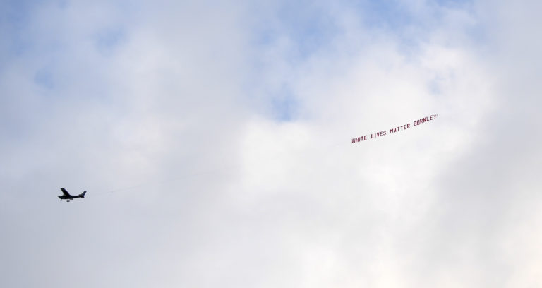 A plane flies the offending banner over the Etihad Stadium.