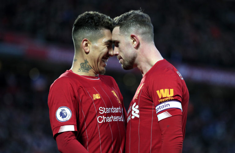 Liverpool captain Jordan Henderson, right, celebrates with Roberto Firmino after scoring during the 4-0 thrashing of Southampton. The England international would go on become to become the first Reds captain to lift the Premier League title