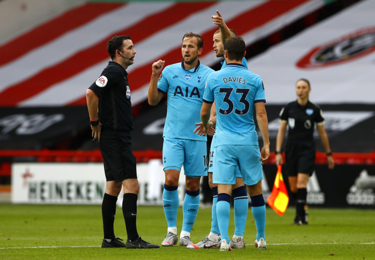 Tottenham's Harry Kane and Eric Dier speak with match referee Chris Kavanagh at half-time 