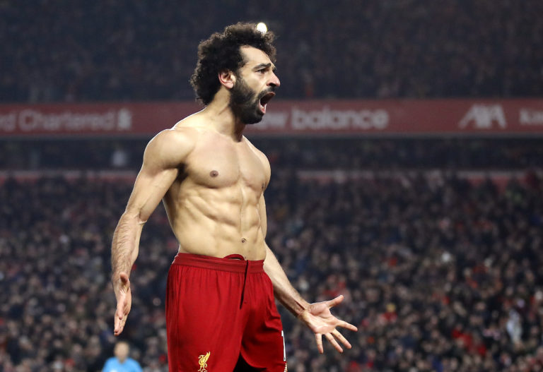Liverpool forward Mohamed Salah reveals his remarkable physique in front of a euphoric Kop after whipping of his shirt having raced away to seal a 2-0 win over Manchester United in January. Victory over arch rivals United moved Jurgen Klopp's side 16 points clear at the top of the table, prompting chants of 'We're gonna win the league' from Reds fans