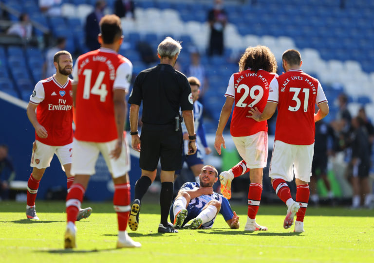 Brighton striker Neal Maupay clutches his neck after falling to the ground following an altercation with fellow Frenchman Matteo Guendouzi. The compatriots clashed during Albion's last-gasp 2-1 win over Arsenal on the first weekend after football resumed. Gunners midfielder Guendouzi has not appeared for the club since